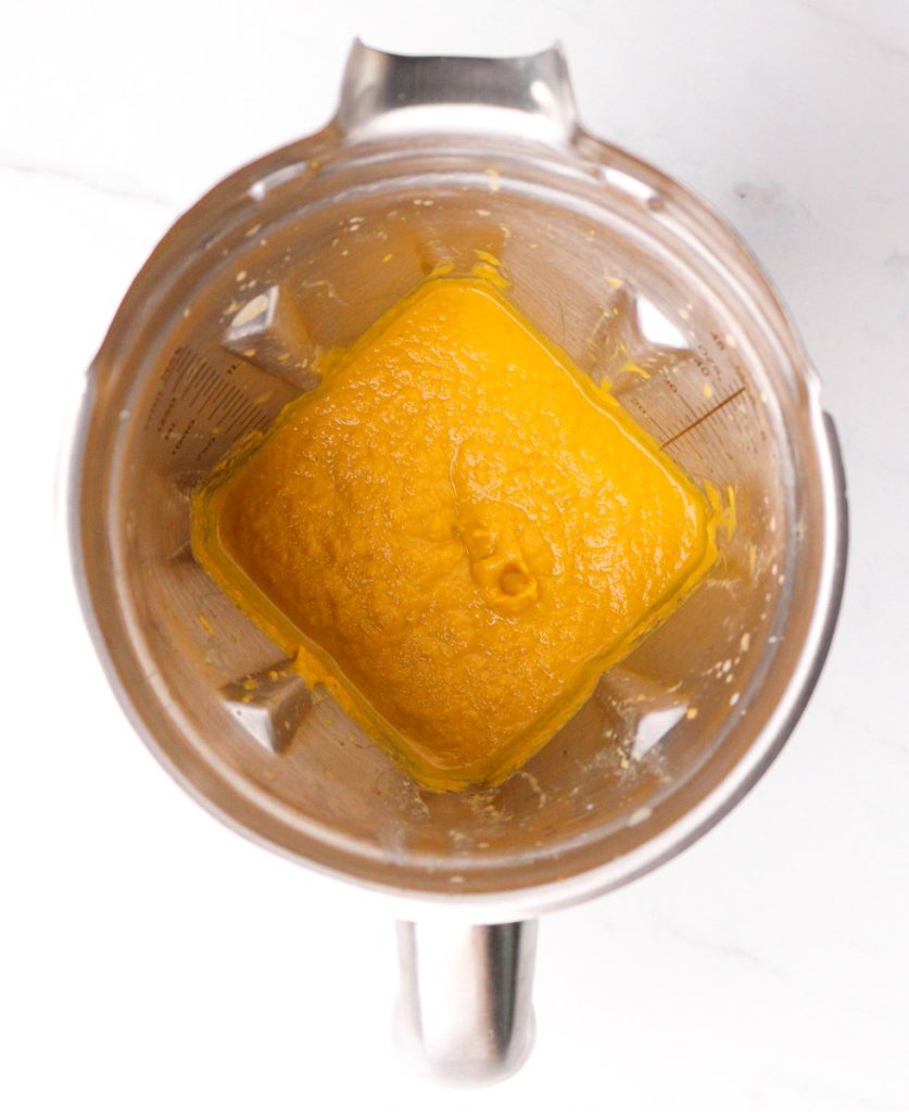 Creamy Buffalo Vegetable Soup in a Vitamix on a white marble counter.